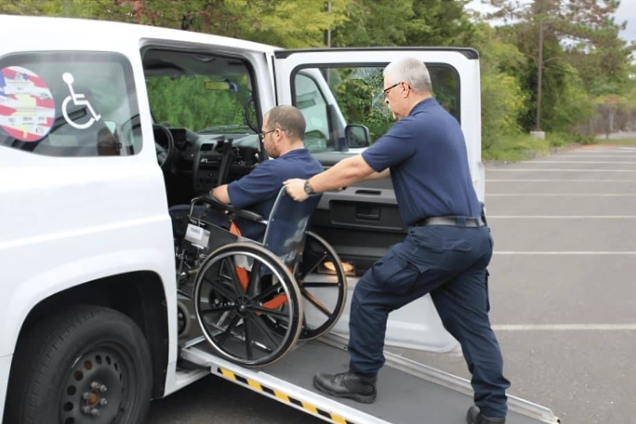 Driver loading a wheelchair rider into an accessible van in Chicago