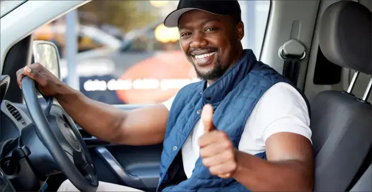 Man in the driver's seat smiling